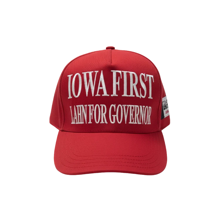 Red "Iowa First" hat displaying Zach Lahn for Governor campaign branding, supporting Iowans showing