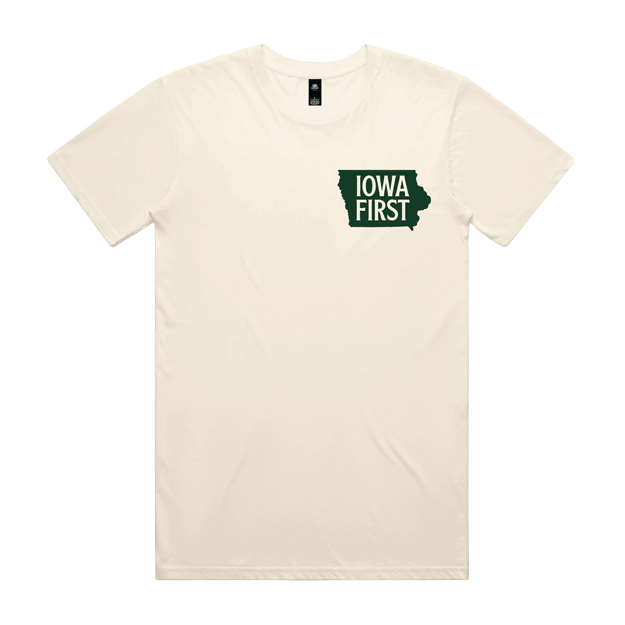 Close-up of a cream-colored t-shirt displaying the "Iowa First" campaign logo, supporting Zach Lahn