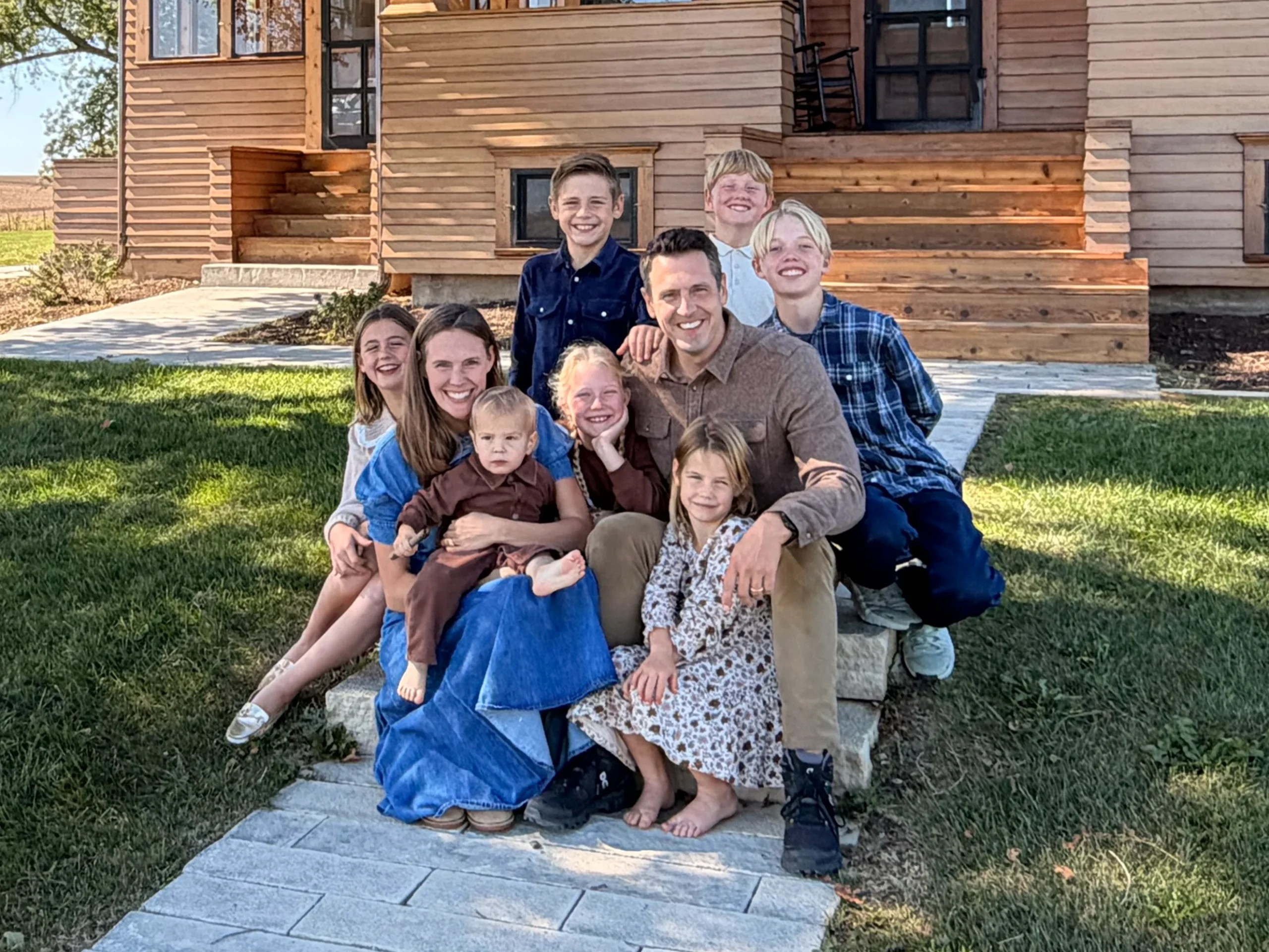 Zach Lahn, a sixth-generation Iowan and father of seven, poses with his family in front