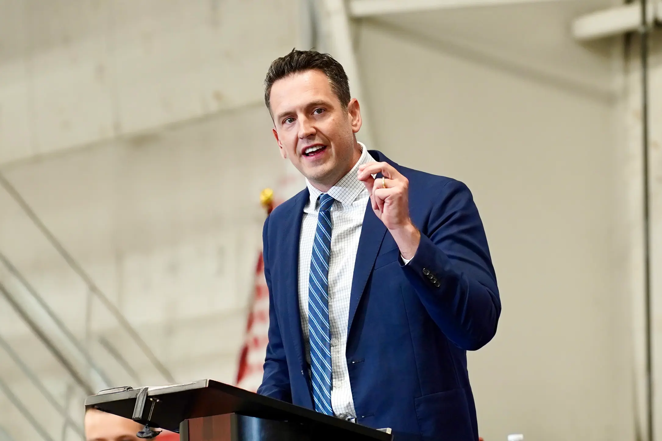 Zach Lahn, Republican gubernatorial nominee, speaks at a podium, preparing for a live debate